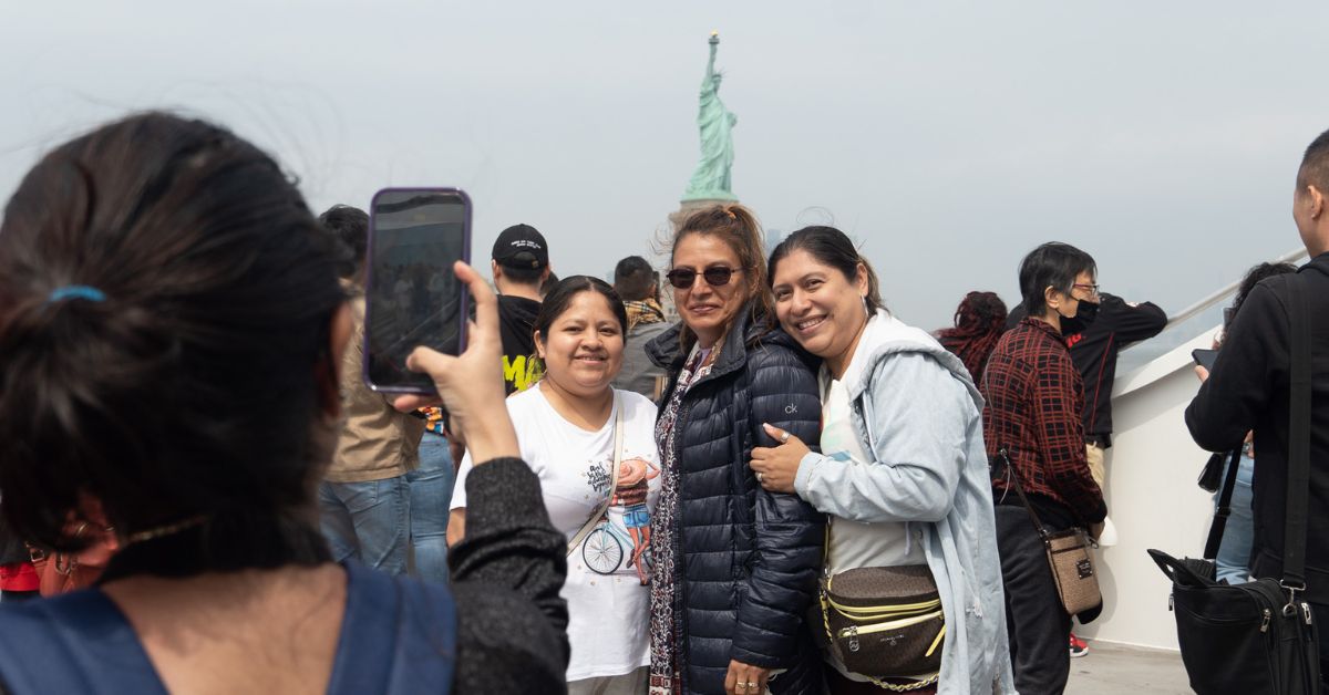 Ladies posing in front of the Statue of Liberty