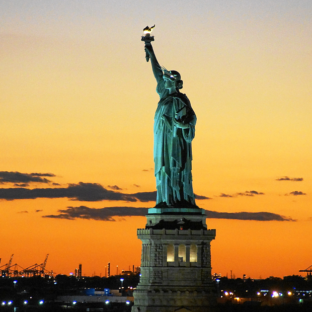 View of the statue of liberty at sunset, the Best Sunset Spot in NYC