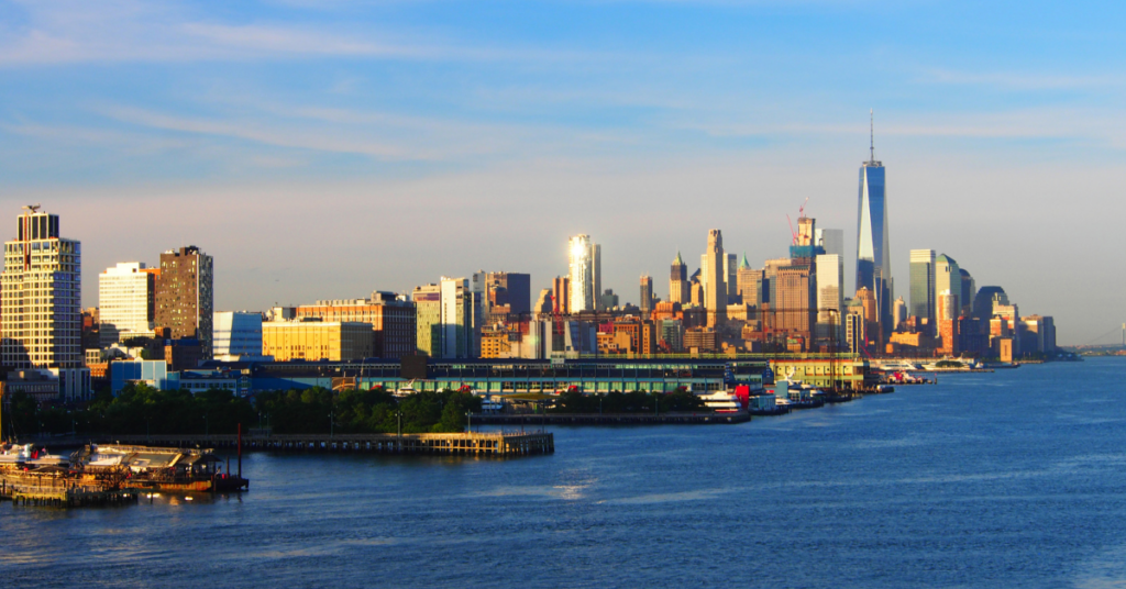 a view of chelsea piers from the hudson river. the new york skyline is in the background