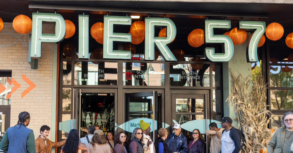 people standing outside of a restaurant on pier 57