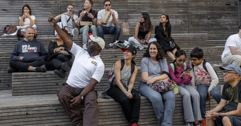 family sitting down taking a break during a guided walking tour in new york city, a great way to safely see the city