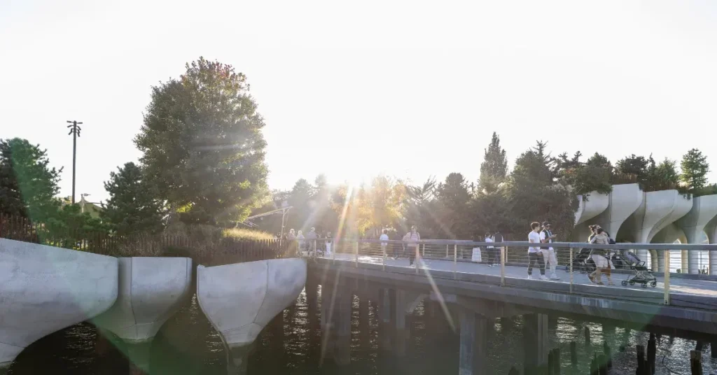 people walking in and out of little island, a popular new york city landmark