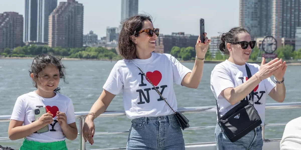 family on vacation to new york city enjoying a sunny day on a boat tour