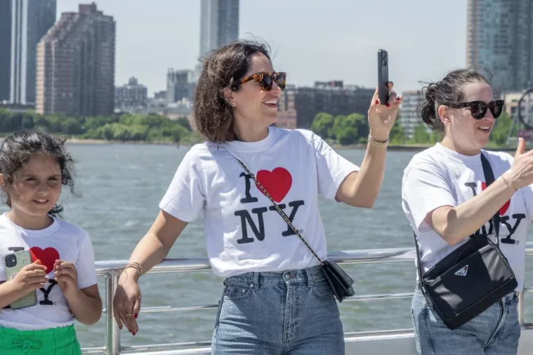 family on vacation to new york city enjoying a sunny day on a boat tour